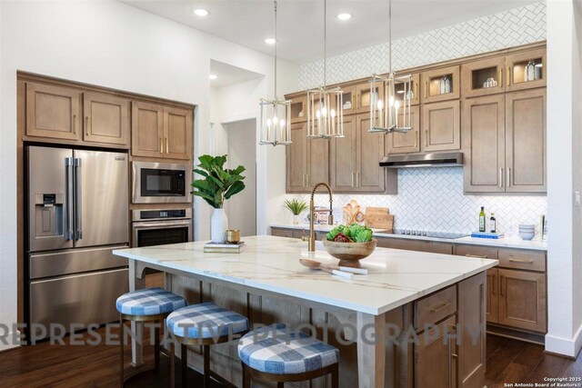 11714 Warlock, San Antonio, TX 78254 - kitchen featuring white cabinets, open floor plan, appliances with stainless steel finishes, a center island with sink, and glass insert cabinets