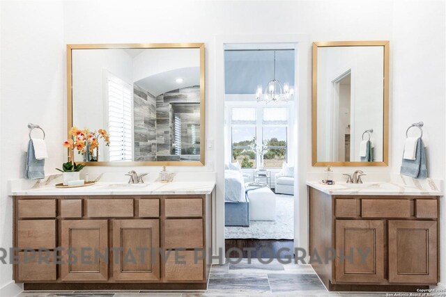 11714 Warlock, San Antonio, TX 78254 - full bath with connected bathroom, a sink, two vanities, vaulted ceiling, and an inviting chandelier