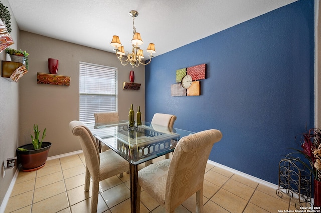 tiled dining room with an inviting chandelier