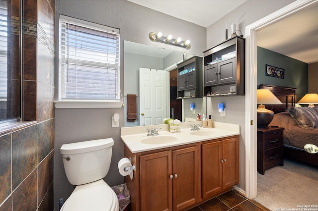 bathroom featuring tile patterned floors, vanity, and toilet