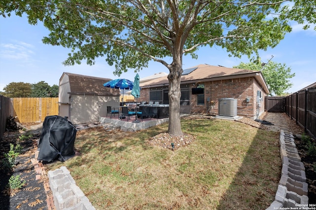 back of house featuring a yard, cooling unit, and a patio area