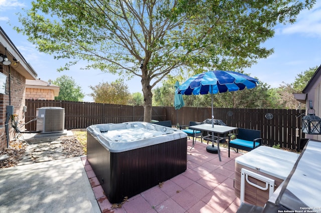 view of patio / terrace featuring central AC and a hot tub