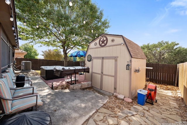 view of patio with a storage unit and central AC