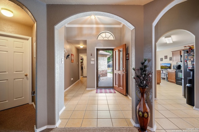 tiled foyer with ornamental molding