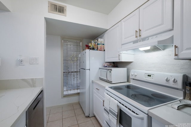 kitchen featuring white appliances, white cabinets, decorative backsplash, light tile patterned flooring, and light stone counters