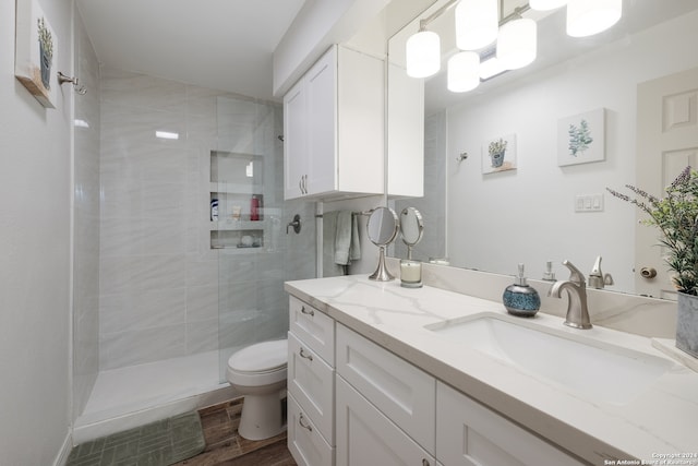 bathroom featuring hardwood / wood-style floors, vanity, toilet, and an enclosed shower