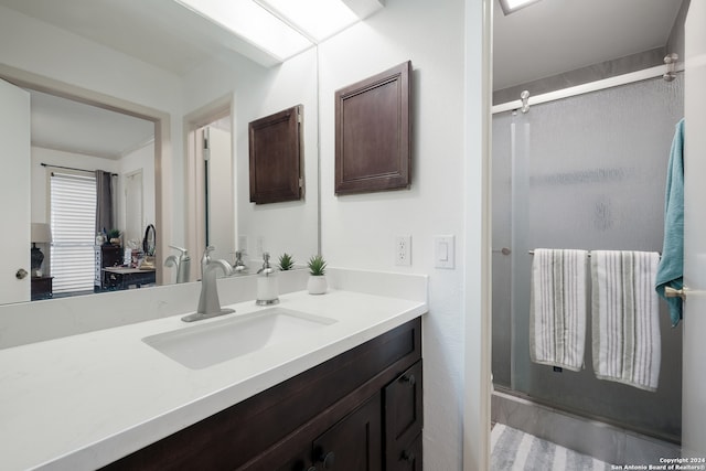 bathroom with wood-type flooring, vanity, and walk in shower