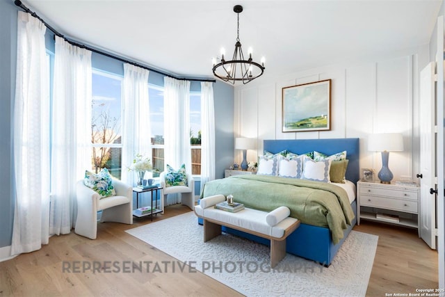 bedroom featuring a notable chandelier and light wood-style flooring