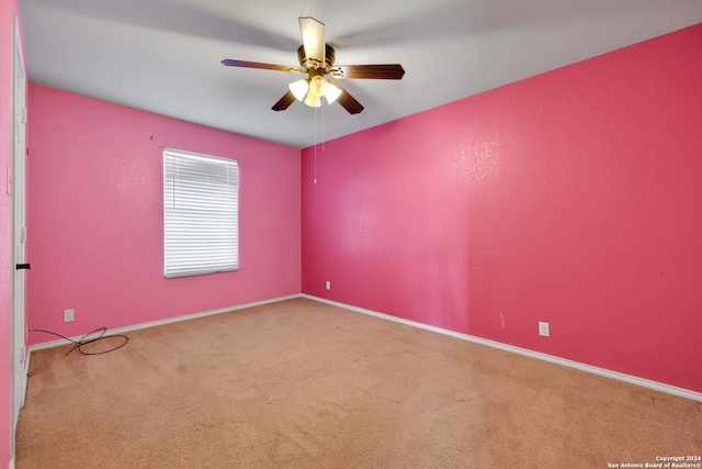 empty room featuring carpet flooring and ceiling fan