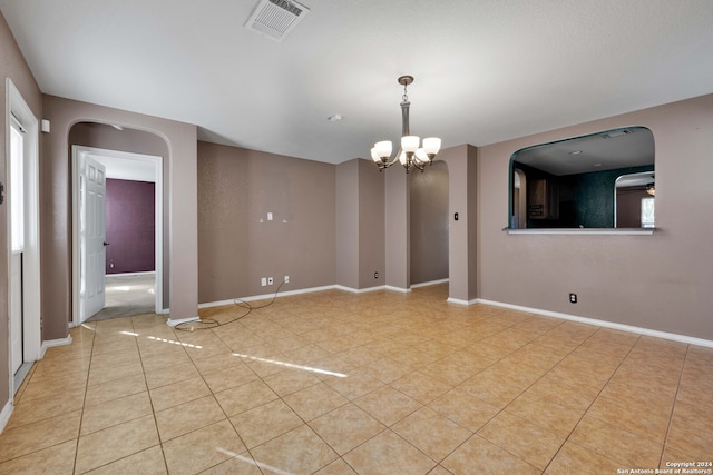 empty room with a notable chandelier