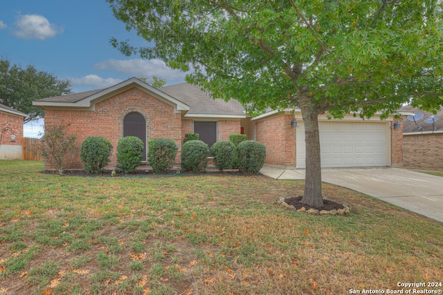 view of front of home with a garage and a front lawn