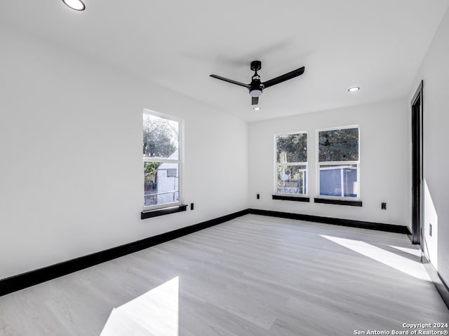 spare room featuring ceiling fan and light hardwood / wood-style floors