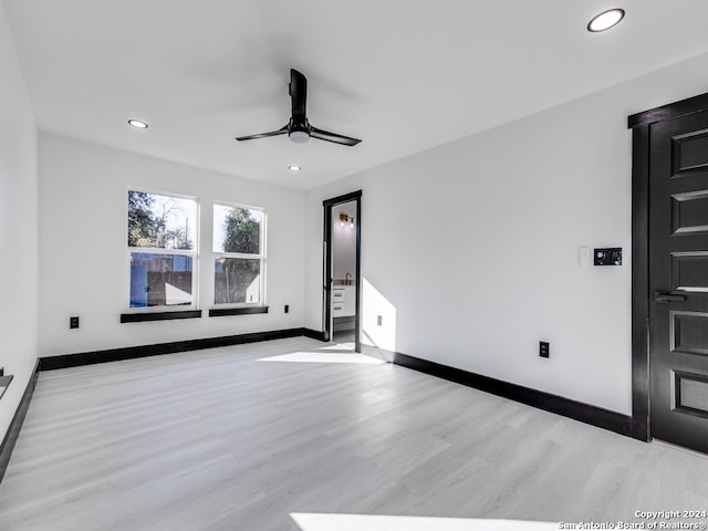 spare room featuring ceiling fan and light hardwood / wood-style floors