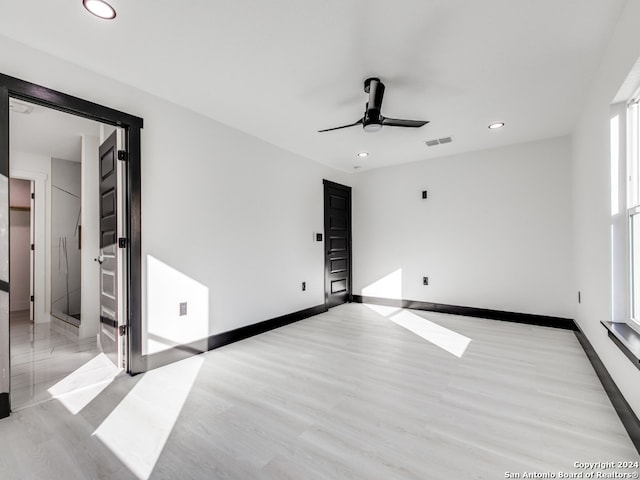 empty room featuring ceiling fan and light wood-type flooring