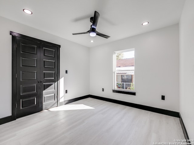 spare room featuring ceiling fan and light wood-type flooring