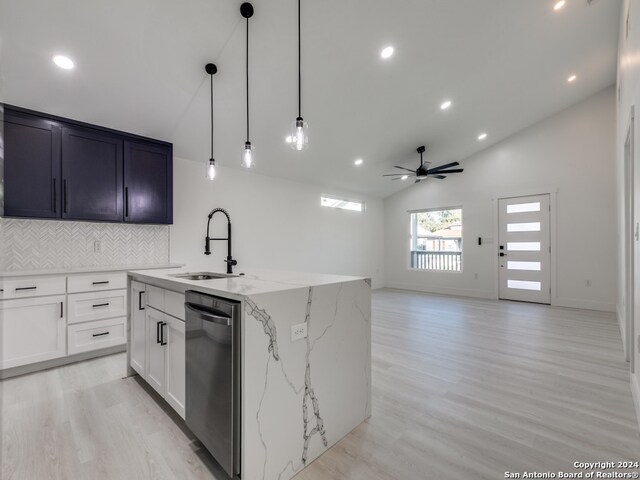 kitchen with dishwasher, sink, an island with sink, pendant lighting, and vaulted ceiling