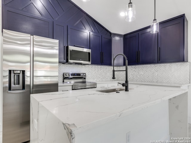 kitchen with light stone countertops, appliances with stainless steel finishes, decorative light fixtures, and sink