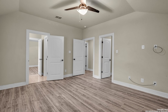 unfurnished bedroom featuring ceiling fan, light wood-type flooring, and lofted ceiling