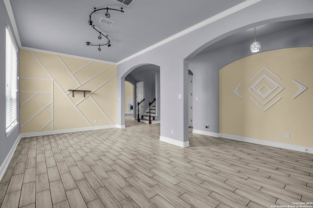 interior space with crown molding, track lighting, and light wood-type flooring