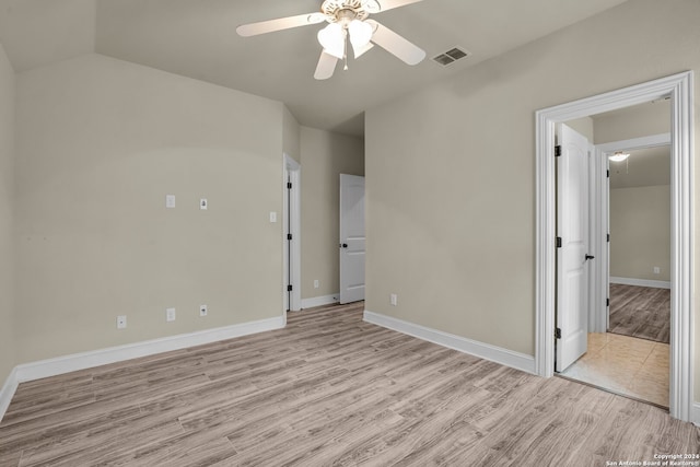 empty room featuring light hardwood / wood-style floors, ceiling fan, and lofted ceiling