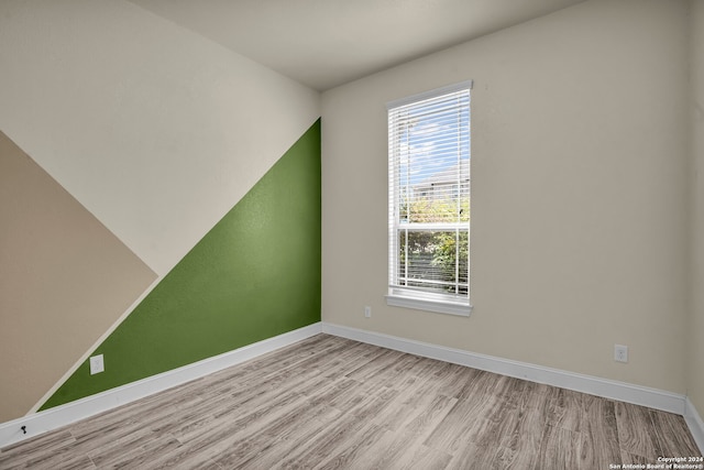 unfurnished room featuring a healthy amount of sunlight and light hardwood / wood-style floors