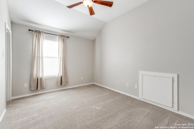 carpeted empty room with ceiling fan and lofted ceiling