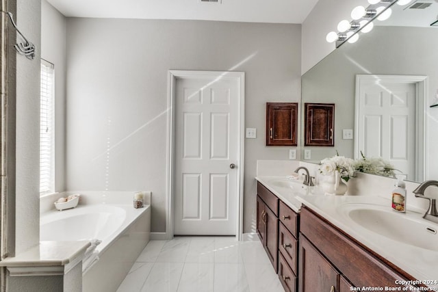 bathroom with a tub and vanity