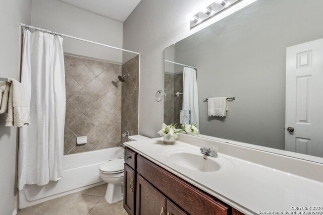 full bathroom featuring vanity, tile patterned flooring, shower / bathtub combination with curtain, and toilet