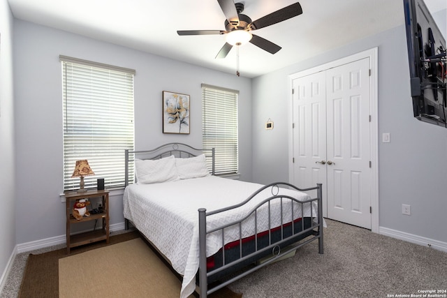 carpeted bedroom featuring a closet and ceiling fan