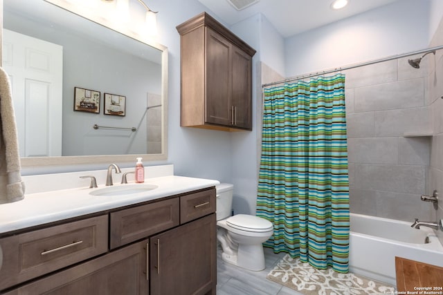 full bathroom with vanity, shower / tub combo, and toilet