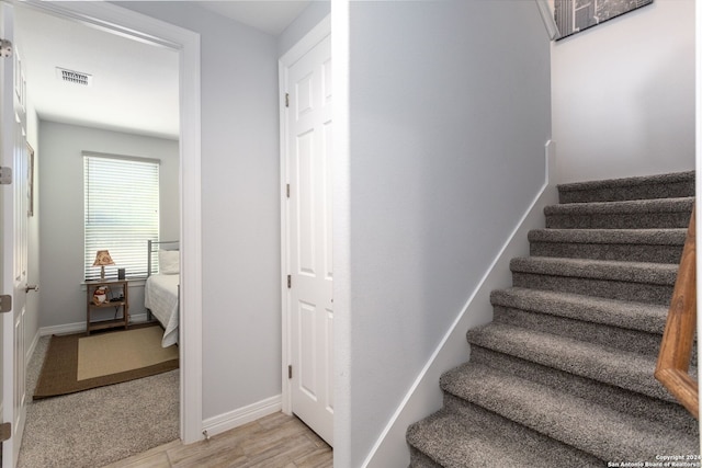 staircase with hardwood / wood-style floors