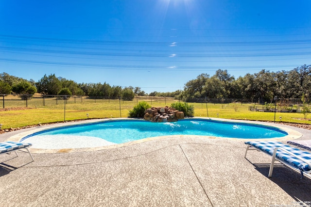 view of pool with a yard and a patio area