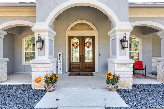 property entrance with a porch and french doors