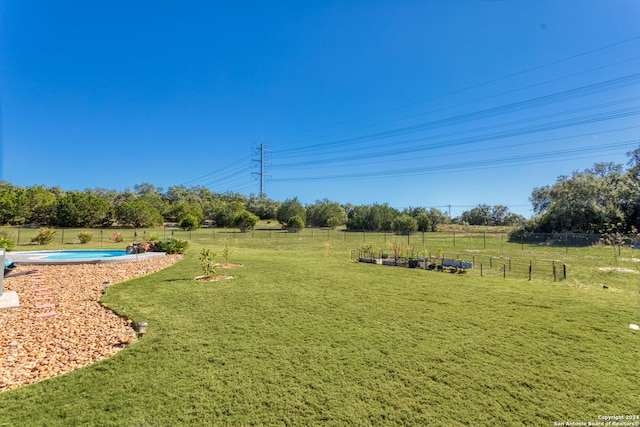 view of yard with a rural view and a fenced in pool