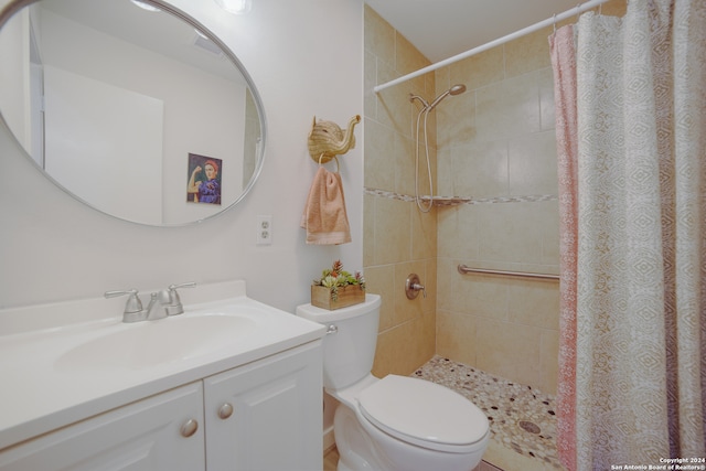 bathroom featuring a shower with shower curtain, vanity, and toilet