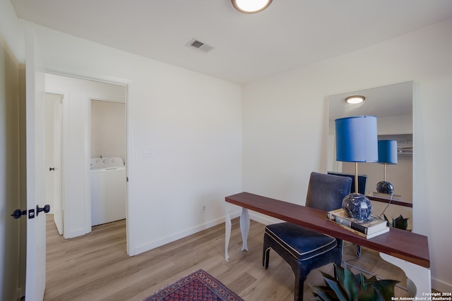 home office featuring light hardwood / wood-style floors and washer / dryer