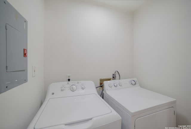 laundry area featuring electric panel and independent washer and dryer