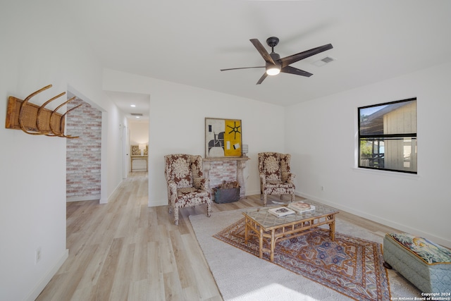 sitting room featuring ceiling fan and light hardwood / wood-style floors