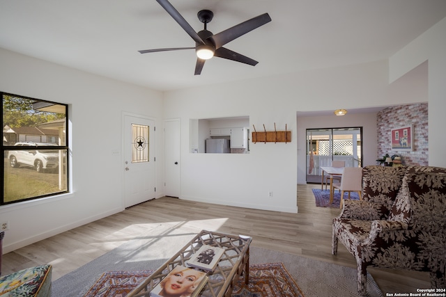 unfurnished living room with ceiling fan and light hardwood / wood-style flooring