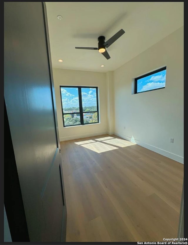 10899 S Hausman Rd Unit 204, San Antonio, TX 78249 - empty room with ceiling fan and wood-type flooring