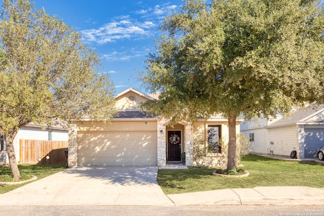 view of front of home with a front yard and a garage