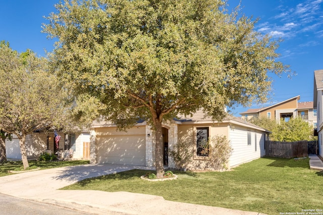 obstructed view of property featuring a garage and a front lawn