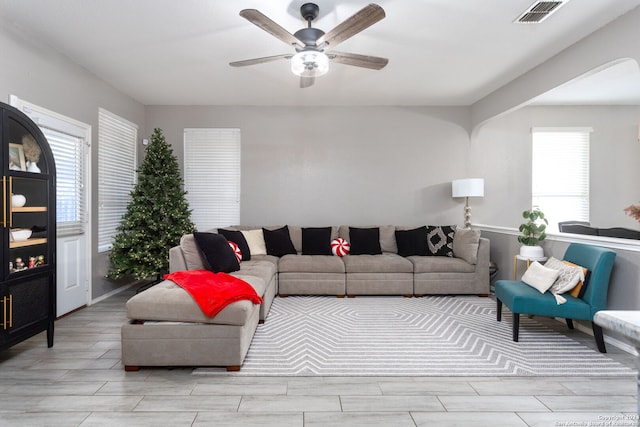 living room with ceiling fan and light wood-type flooring