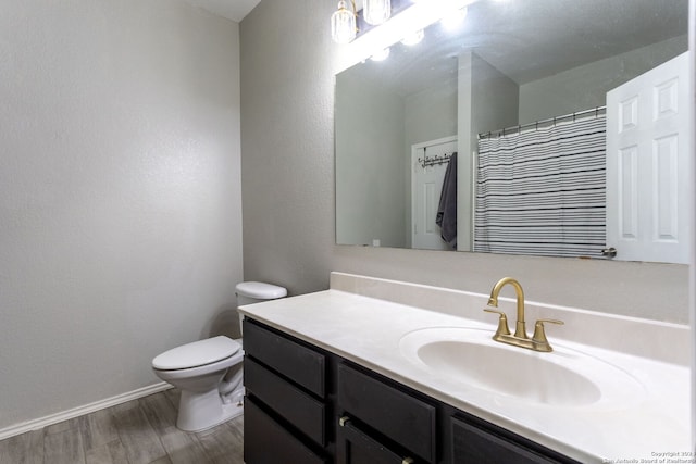 bathroom featuring hardwood / wood-style flooring, vanity, toilet, and a shower with shower curtain