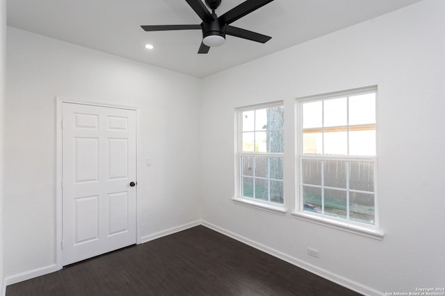 spare room with ceiling fan and dark wood-type flooring