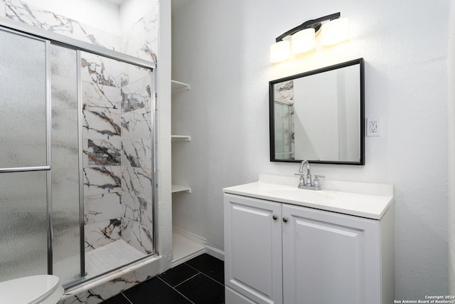 bathroom with tile patterned flooring, vanity, toilet, and walk in shower