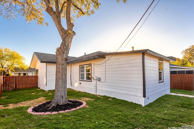 view of side of home with a lawn