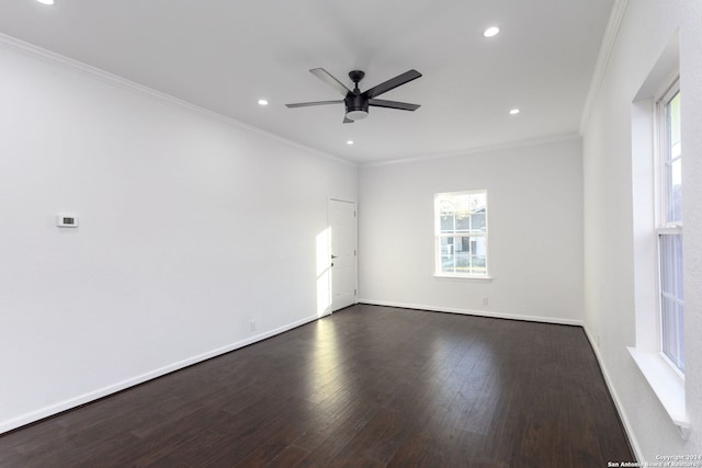 spare room featuring crown molding, ceiling fan, and dark wood-type flooring