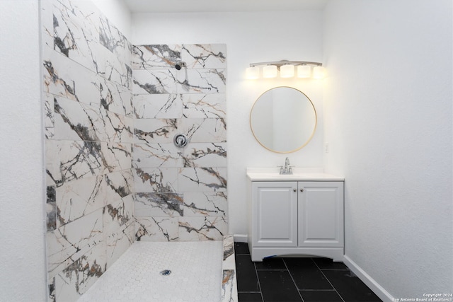 bathroom featuring a tile shower, vanity, and tile patterned floors