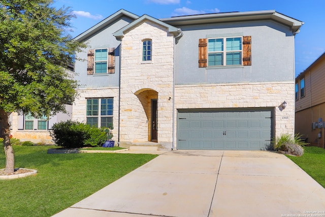 view of front of home featuring a garage and a front yard